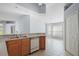 Open kitchen with wood cabinets and a breakfast bar, perfect for casual dining and entertaining at 33234 Kaylee Way, Leesburg, FL 34788