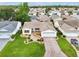 Beautiful aerial view of single-story home with manicured lawn and stone driveway in a lovely neighborhood at 3460 Idlewood Loop, The Villages, FL 32162