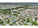 Expansive aerial view of a well-planned community with neatly arranged homes and beautiful landscaping at 3460 Idlewood Loop, The Villages, FL 32162