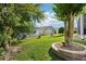 Lush backyard with mature trees, well-kept landscaping, and a peaceful atmosphere for relaxation and outdoor activities at 3460 Idlewood Loop, The Villages, FL 32162