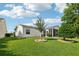 Picturesque backyard featuring green lawn, mature trees, and a screened-in porch, creating a serene outdoor space at 3460 Idlewood Loop, The Villages, FL 32162