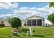 Relaxing backyard view with a screened lanai, manicured landscaping, and a peaceful setting for outdoor enjoyment at 3460 Idlewood Loop, The Villages, FL 32162