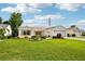 Inviting single-story home boasting a green lawn, well-maintained landscaping, and an attached two-car garage at 3460 Idlewood Loop, The Villages, FL 32162