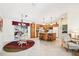 Bright kitchen with an island with seating, wood cabinets, and seamlessly connects to an outdoor screened patio at 3460 Idlewood Loop, The Villages, FL 32162
