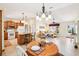Open floor plan showcasing the kitchen with island seating and seamless flow to the living area at 3460 Idlewood Loop, The Villages, FL 32162