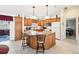 Spacious kitchen featuring wood cabinets, granite countertops, an island with seating, and modern appliances at 3460 Idlewood Loop, The Villages, FL 32162