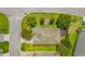 Overhead view of a home showcasing its roof, landscaping, and proximity to the road and neighboring houses at 3604 Corsica Ln, Clermont, FL 34711