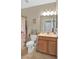 Cozy bathroom with a single sink vanity, neutral color palette, and decorative accents at 3604 Corsica Ln, Clermont, FL 34711