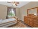 Cozy bedroom with wood-look flooring and large dresser at 3604 Corsica Ln, Clermont, FL 34711