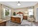 Well-lit bedroom showcasing a decorative chandelier, large windows and wood-look floors at 3604 Corsica Ln, Clermont, FL 34711
