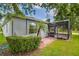 Exterior view of a home with a screened-in patio and a well-maintained lawn at 3604 Corsica Ln, Clermont, FL 34711