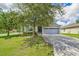 Charming single-story home with a well-manicured lawn, mature trees, and a two-car garage at 3604 Corsica Ln, Clermont, FL 34711