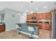 Modern kitchen boasts an island, pendant lighting, stainless steel appliances, and granite countertops at 3604 Corsica Ln, Clermont, FL 34711