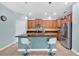 Bright kitchen featuring an island with bar stools, stainless steel appliances, and abundant wood cabinetry at 3604 Corsica Ln, Clermont, FL 34711