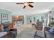 Open-concept living area with an island kitchen, pendant lighting, and ample counter space at 3604 Corsica Ln, Clermont, FL 34711