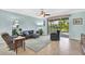 Inviting living room with tile floors, ceiling fan, and sliding doors to the lanai at 3604 Corsica Ln, Clermont, FL 34711