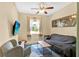 Cozy living room features a window view, TV, neutral walls, carpet, and comfortable seating at 3604 Corsica Ln, Clermont, FL 34711
