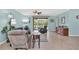 Comfortable living room featuring neutral colors, tile floors, and a view of the screened lanai at 3604 Corsica Ln, Clermont, FL 34711