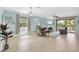 Open-concept living room features tile floors, large windows, and comfortable seating, creating a welcoming atmosphere at 3604 Corsica Ln, Clermont, FL 34711