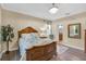 Spacious main bedroom showcasing a wooden bedframe, wood floors, and ensuite bathroom at 3604 Corsica Ln, Clermont, FL 34711