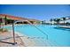 Resort-style community pool with palm trees and a view of the clubhouse at 3604 Corsica Ln, Clermont, FL 34711