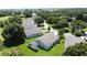 Expansive aerial view of a home nestled in a lush, green community with mature trees at 3716 Eversholt St, Clermont, FL 34711