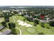 Panoramic aerial view of property set on a golf course with nearby schools at 3716 Eversholt St, Clermont, FL 34711