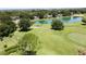 Aerial view of trees, golf course and a pond in this desirable neighborhood at 3716 Eversholt St, Clermont, FL 34711