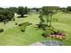Scenic backyard with a manicured lawn, lush trees, and a view of the golf course at 3716 Eversholt St, Clermont, FL 34711