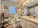Bright bathroom with decorative features and a vanity, offering a clean and stylish space at 3716 Eversholt St, Clermont, FL 34711