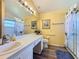 Well-lit bathroom featuring a vanity with ample counter space and a walk-in shower at 3716 Eversholt St, Clermont, FL 34711