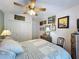 Bright bedroom featuring a ceiling fan, storage, and comfortable furnishings at 3716 Eversholt St, Clermont, FL 34711