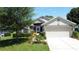 Inviting single Gathering home featuring mature landscaping and a two-car garage at 3716 Eversholt St, Clermont, FL 34711
