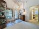 Bright foyer with decorative glass door, wooden floors, neutral carpet, and view of a bathroom at 3716 Eversholt St, Clermont, FL 34711