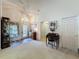 Inviting foyer with wood-look flooring, neutral carpet, and furniture, creating a welcoming entrance at 3716 Eversholt St, Clermont, FL 34711