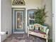 Cozy front entry featuring a decorative bench, glass door, and lovely sidelight windows at 3716 Eversholt St, Clermont, FL 34711