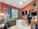 Home office with desk, recliner chair, and natural light, creating a comfortable workspace at 3716 Eversholt St, Clermont, FL 34711