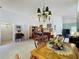 Spacious living room with dining area, desk, and natural light, perfect for working from home at 3716 Eversholt St, Clermont, FL 34711