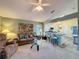 Open-concept living area showcases stylish seating with kitchen view and great natural light at 3716 Eversholt St, Clermont, FL 34711