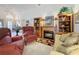 Inviting living room featuring a cozy fireplace with built-in shelving and classic furnishings at 3716 Eversholt St, Clermont, FL 34711