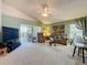 Bright living room with sliding glass doors to patio, complemented by comfortable seating and decor at 3716 Eversholt St, Clermont, FL 34711