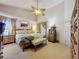 Tranquil main bedroom suite with a vaulted ceiling, ceiling fan, and traditional furnishings at 3716 Eversholt St, Clermont, FL 34711