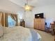 Bright main bedroom featuring sliding door access, a ceiling fan, and a spacious layout at 3716 Eversholt St, Clermont, FL 34711