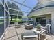 Relaxing screened-in patio with comfortable seating and serene backyard views at 3716 Eversholt St, Clermont, FL 34711