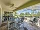 Spacious screened-in patio with ceiling fan, dining table, and views of landscaped yard at 3716 Eversholt St, Clermont, FL 34711