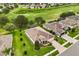 An aerial view of the home showcases the lush landscaping and long driveway at 4210 Arlington Ridge Blvd, Leesburg, FL 34748