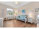 Bright bedroom with white furniture and a floral futon, illuminated by a ceiling fan at 4210 Arlington Ridge Blvd, Leesburg, FL 34748