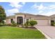 Inviting home features a well-manicured lawn and charming landscaping at 4210 Arlington Ridge Blvd, Leesburg, FL 34748