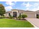 Charming single-story home featuring manicured lawn, flowerbeds and a screened entrance way at 4210 Arlington Ridge Blvd, Leesburg, FL 34748