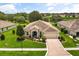 Inviting single-story home with lush landscaping, well-manicured lawn and a spacious driveway at 4210 Arlington Ridge Blvd, Leesburg, FL 34748